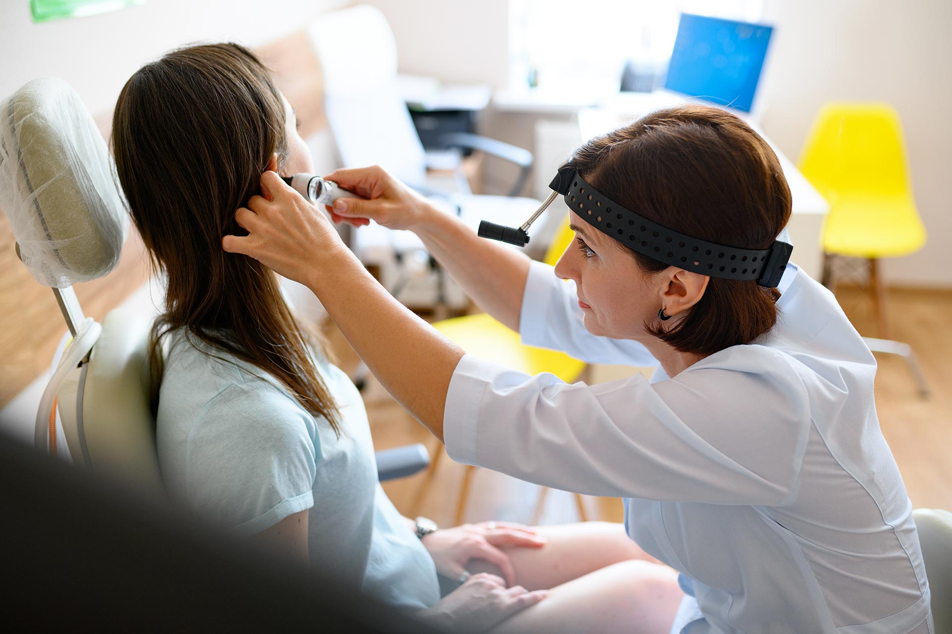 female-ent-doctor-and-patient-in-office-ear-exam-2021-08-29-07-38-46-utc.jpg
